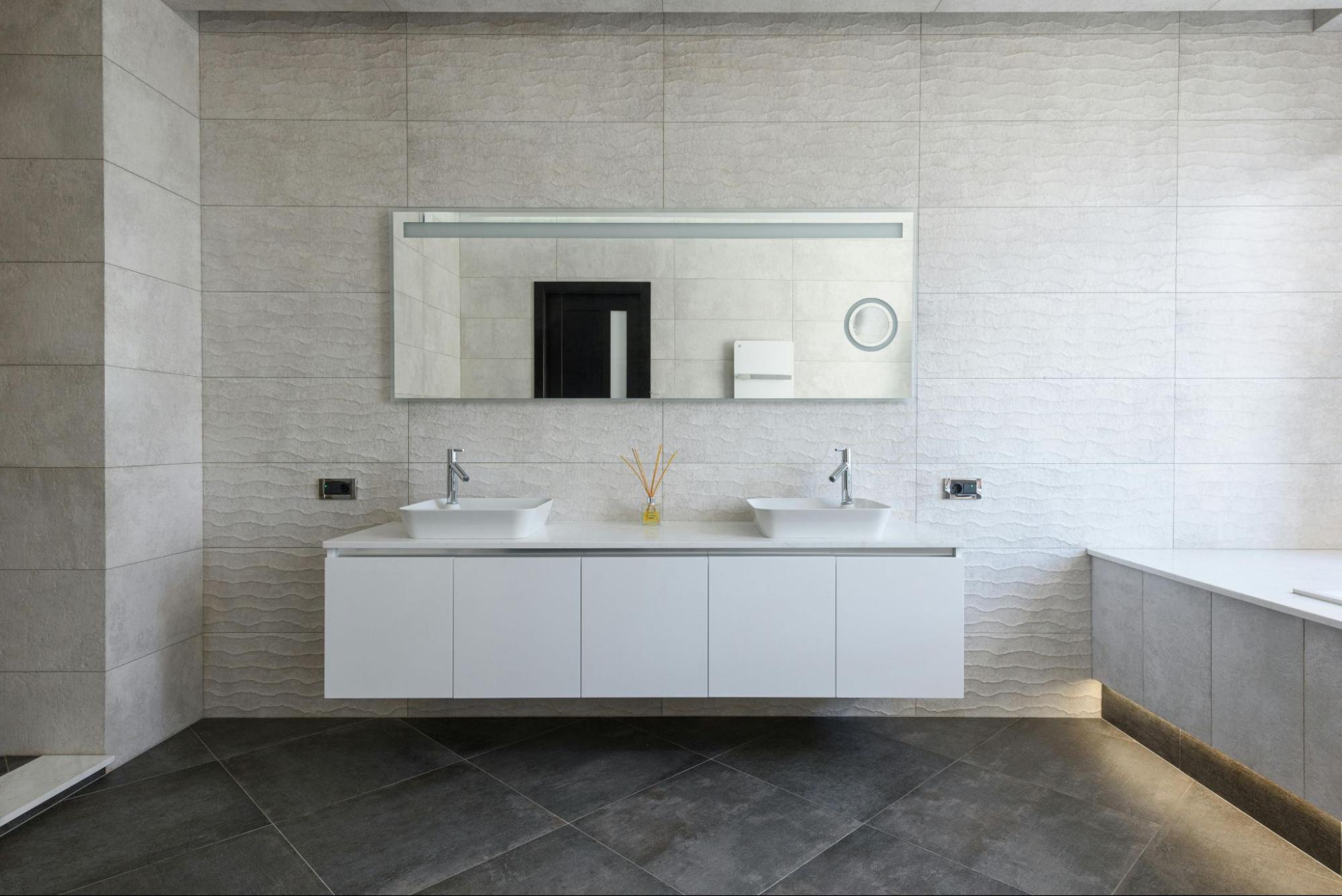 A sleek modern bathroom featuring a floating double vanity, textured wall tiles and clean minimalist design. Bright, spacious and styled for contemporary living
